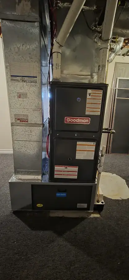 Goodman 96% AFUE gas furnace with new sheet-metal plenum installed by Synoptic HVAC in a Manitoba basement